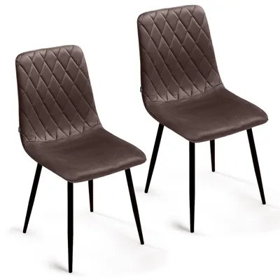 Two brown velvet dining chairs with diamond tufting on a white background.
