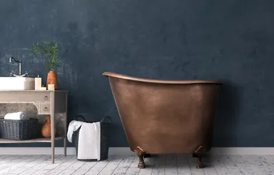 A copper bathtub is shown in a bathroom setting with a sink and vanity.