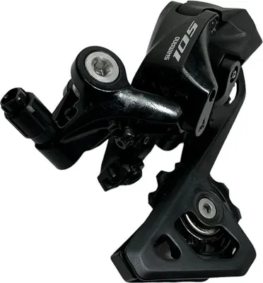 A black bicycle rear derailleur is shown against a white background.