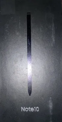 A close-up of a stylus pen and the text 'Note10' on a dark, textured background.