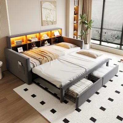 A bedroom with a multi-functional sofa bed, showing its extended configuration and storage drawers.