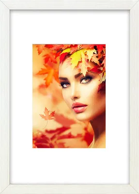 A woman's face is adorned with autumn leaves, with more leaves blurred in the background.