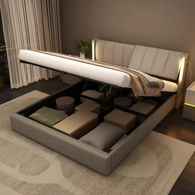 A bed with its storage compartment open, revealing stored items.