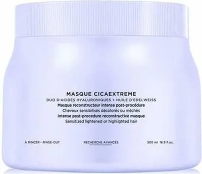 A white jar of hair mask with text on the front.