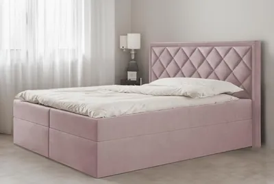 A pink upholstered bed with a diamond-stitched headboard is shown in a bedroom setting.
