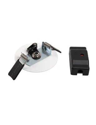 A white circular mounting plate with metal and black plastic components, and a separate black rectangular electronic component, are displayed against a white background.