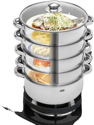 A multi-tiered stainless steel steamer pot filled with food, placed on a black stovetop.