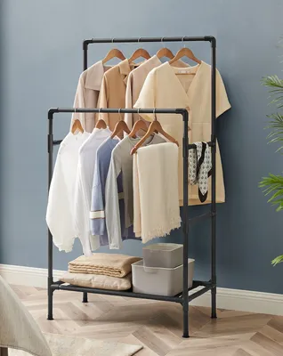 A SONGMICS clothing rack with clothes and storage boxes.