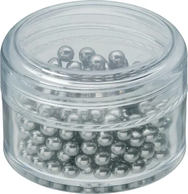 A clear, well-lit studio shot of a small, transparent plastic container filled with numerous small, metallic ball bearings.