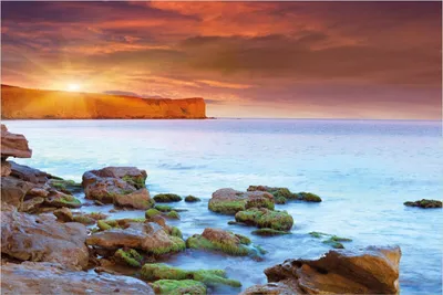 Produktbild von Wallario selbstklebendes Poster - Sonnenaufgang am Meer mit Landzunge und Felsen im Wasser, Größe: 100 x 150 cm