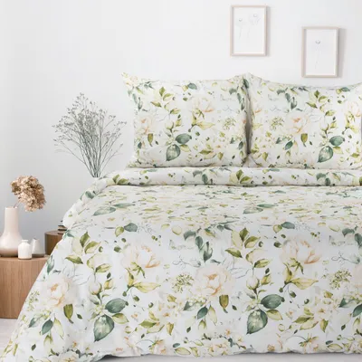 A bed with floral patterned bedding.