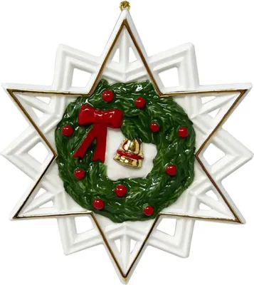 A Christmas ornament shaped like a star with a wreath in the center.