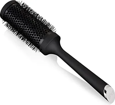 A studio shot of a black radial hairbrush against a white background.