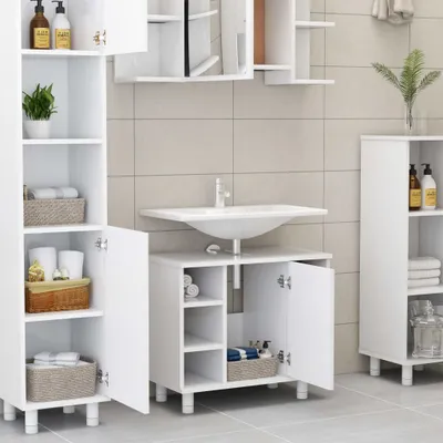 A white bathroom vanity with a sink and storage cabinets, set against a tiled wall.
