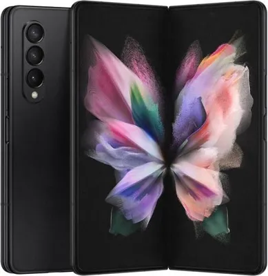 A black Samsung Galaxy Z Fold3 smartphone is shown unfolded, displaying a colorful butterfly-like wallpaper on its screen. The phone is positioned diagonally, with the back of the phone visible on the left and the unfolded screen on the right.