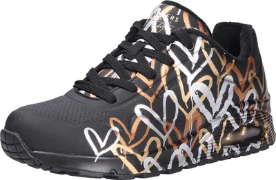 A single black sneaker with a heart pattern in gold and white.