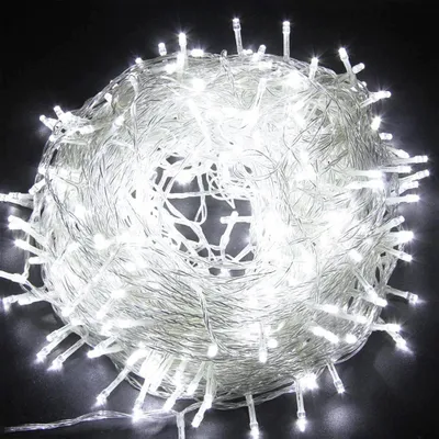 A tangled ball of white LED string lights on a black background.