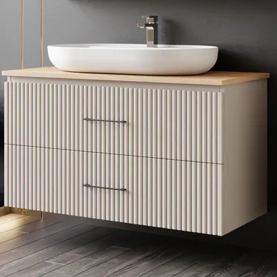 A modern bathroom vanity with a vessel sink and faucet.