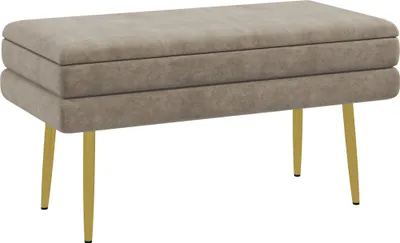 A beige upholstered bench with gold legs against a white background.