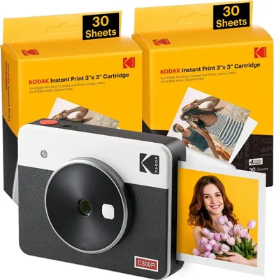 A Kodak Mini Shot 3 Retro instant camera with two boxes of 3x3 inch print cartridges.