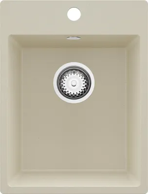 A top-down view of a beige kitchen sink with a drain.