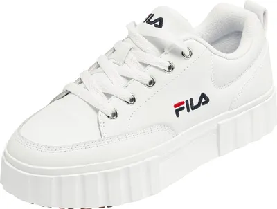 A white Fila sneaker is shown from a slightly elevated side angle against a white background.