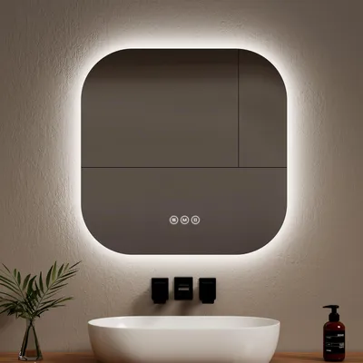 A modern bathroom vanity with a sink and a lighted mirror above it.