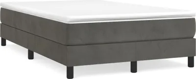 A dark gray boxspring bed with a white mattress on top, shown from a side angle with black legs.