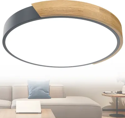 A modern ceiling light with a wood and gray finish is shown against a white background, with a hint of a living room setting below.
