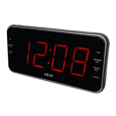 A black digital alarm clock with a red LED display, showing the time 12:08. The brand name 'AKAI' is visible below the display.