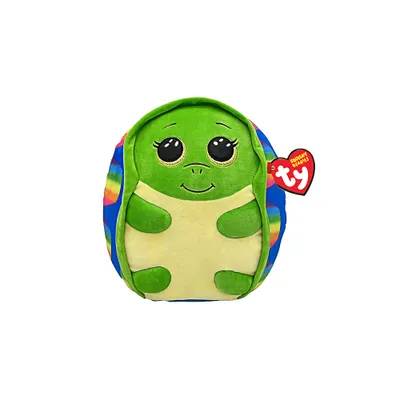 A plush toy turtle with a rainbow shell pattern, shown from the front against a white background. A red Ty tag is attached to its side.