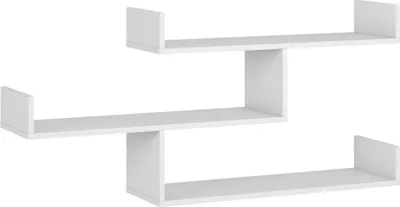 A white, modern, zigzag-shaped wall shelf against a white background.