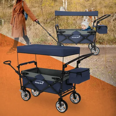 A person pulling a wagon with a baby in it, with another wagon in the foreground.