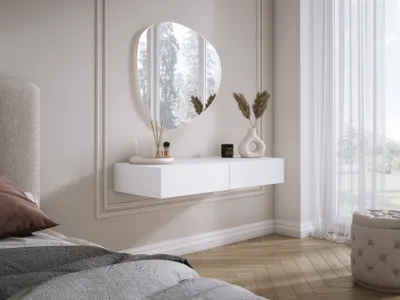 A bedroom setting with a floating white vanity and mirror.