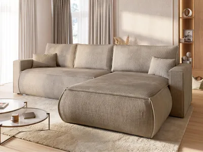 A modern living room with a beige sectional sofa and coffee tables.