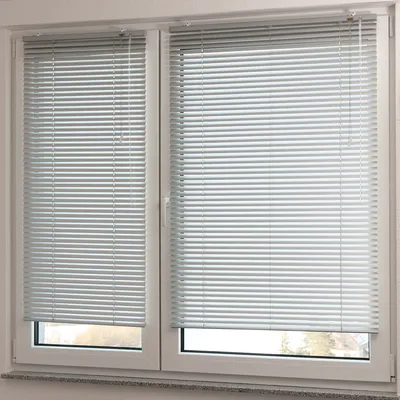 Two windows with silver blinds are shown.