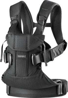 A black BabyBjörn baby carrier is shown against a white background.