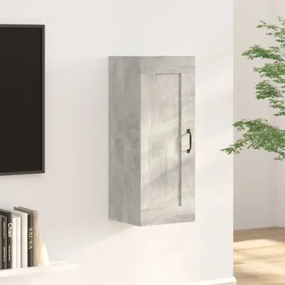 A gray wall-mounted cabinet is shown on a white wall, with a portion of a television and books on a shelf visible to the left, and a plant in the background to the right.