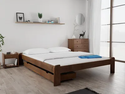 A bedroom scene with a wooden bed, nightstand, and dresser.