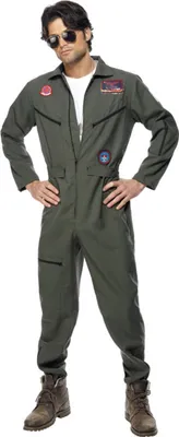 A man wearing a green pilot costume with patches, sunglasses, and boots, posing against a white background.