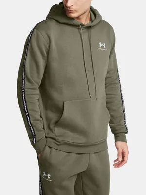 A man wearing an olive green Under Armour hoodie and matching sweatpants.
