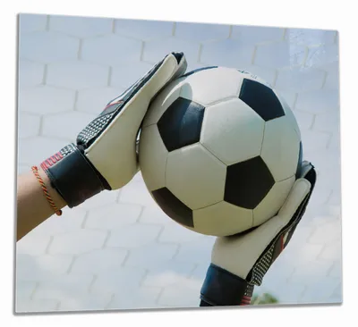 Produktbild von Wallario Herdabdeckplatte aus Glas, Größe 60 x 52 cm 1-teilig, Motiv Fußball - Torwart im Tor vor blauem Himmel