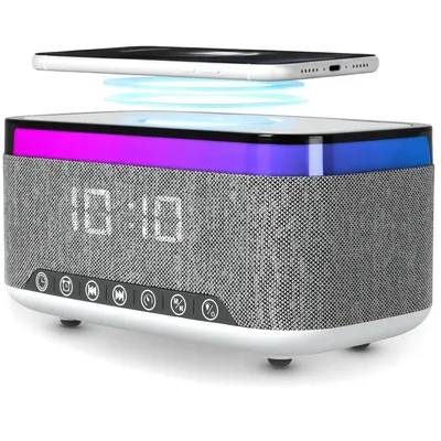 A digital alarm clock with a Bluetooth speaker and wireless charging pad.