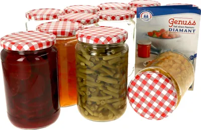 A collection of glass jars with red and white checkered lids, some filled with food items like beets, jam, and green beans, and a product box in the background.