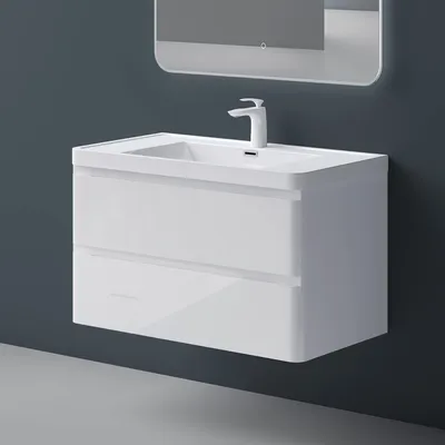 A white bathroom vanity with two drawers and a sink is mounted on a dark gray wall.