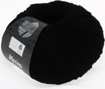 A ball of black yarn with a label wrapped around it.