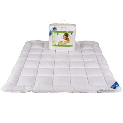 A white duvet is laid out flat on a white background, with its packaging placed on top of it.