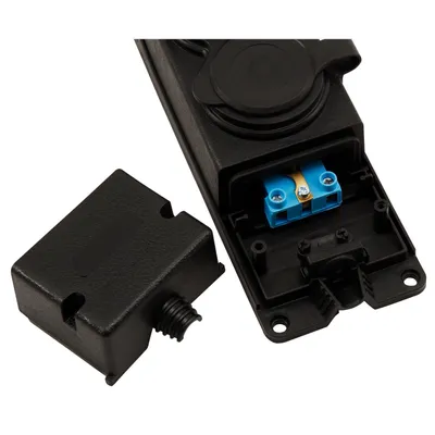 A close-up view of an electrical plug with its cover removed, revealing the internal wiring terminal.