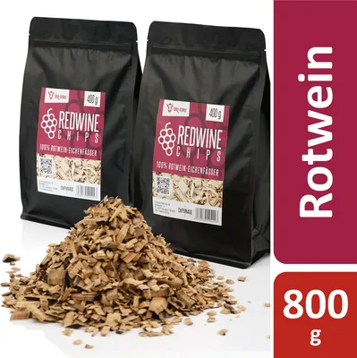 Two bags of red wine chips and a pile of wood chips in front of them.