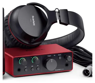 A close-up studio shot of a Focusrite Scarlett Solo audio interface, headphones, and cables.